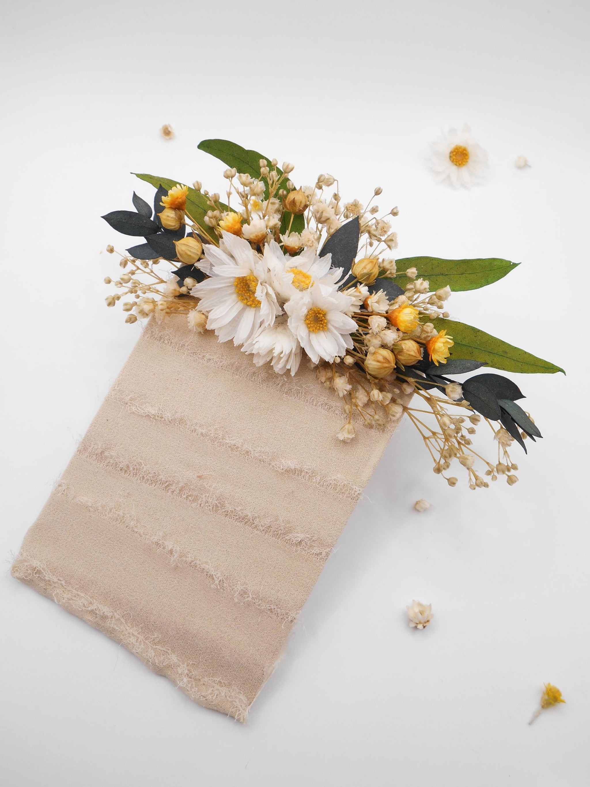 Pocket flower on a textured beige base with daisies and green eucalyptus