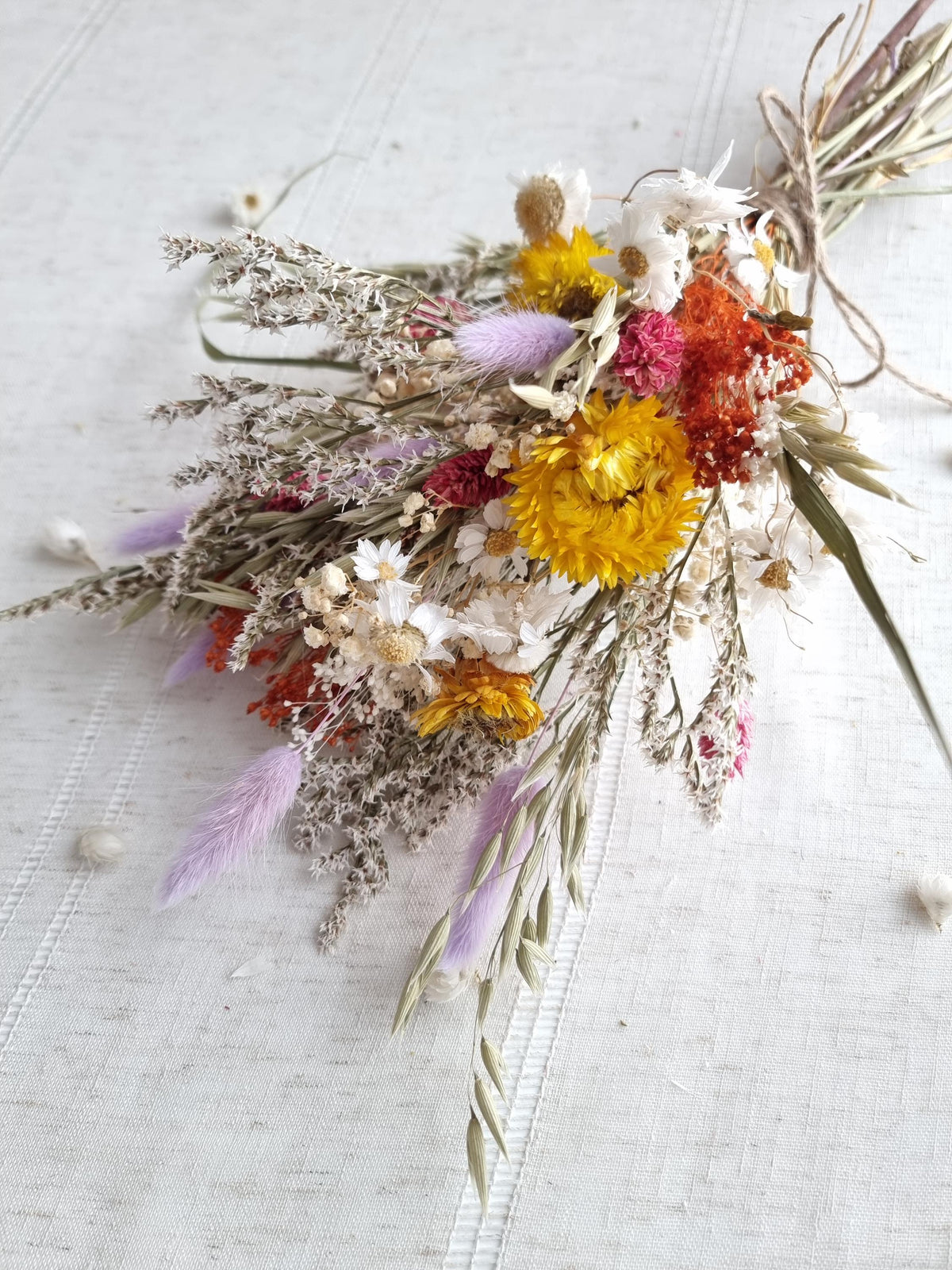 Wildblumenstrauß, pastellfarbene, fliedergelbe und rote Trockenblumen, natürliche Wiesenblumen 