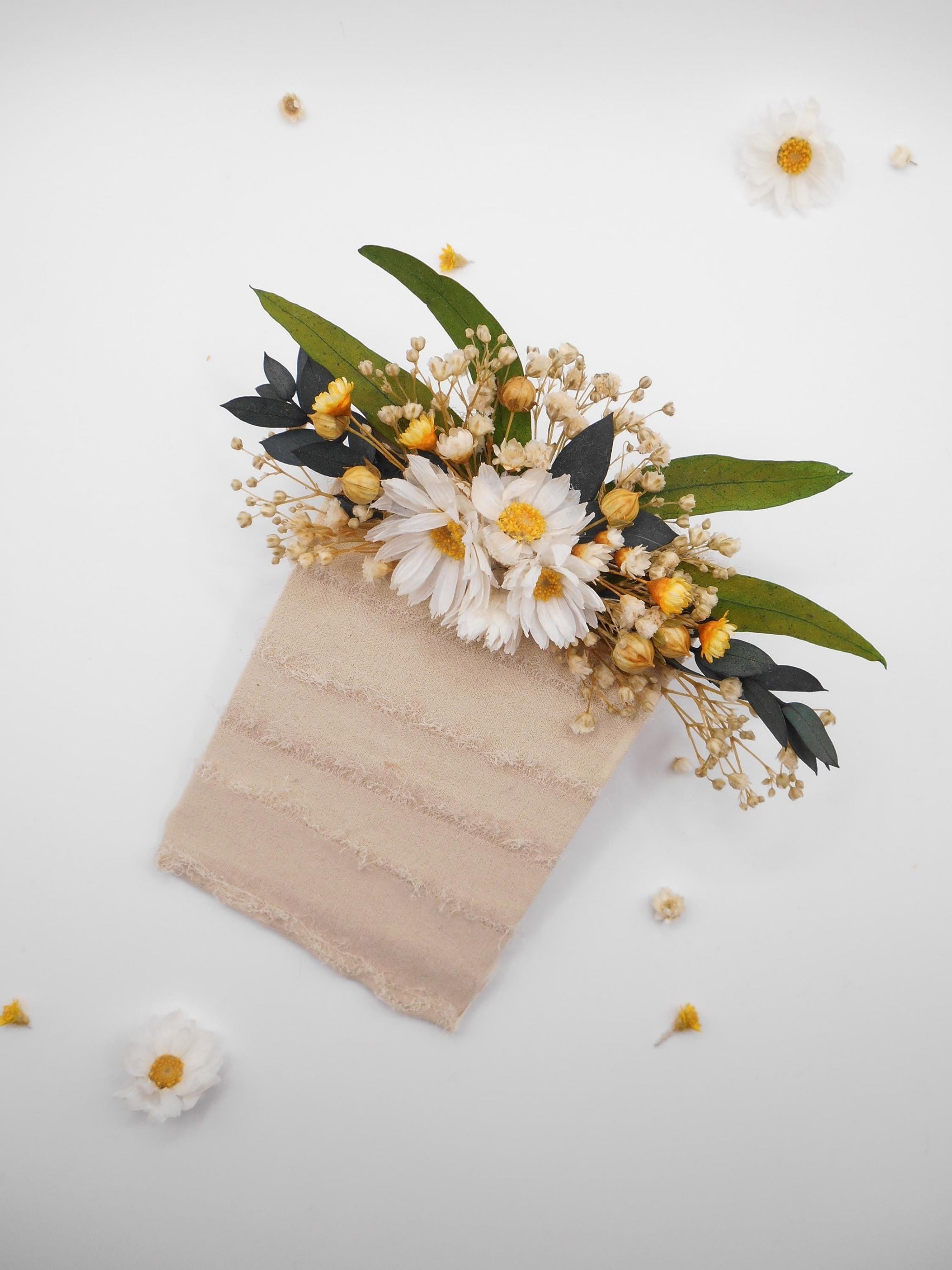 Pocket flower on a textured beige base with daisies and green eucalyptus